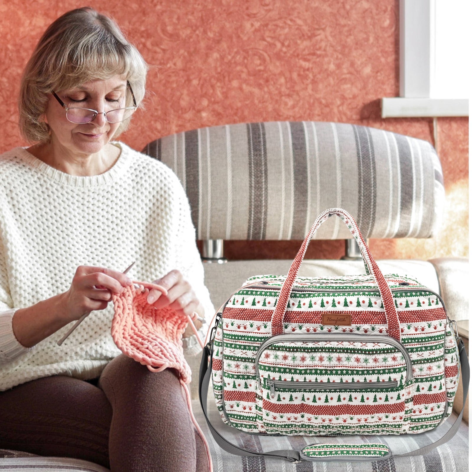 Woolique craft bag in red and green Christmas pattern sitting beside a lady knitting