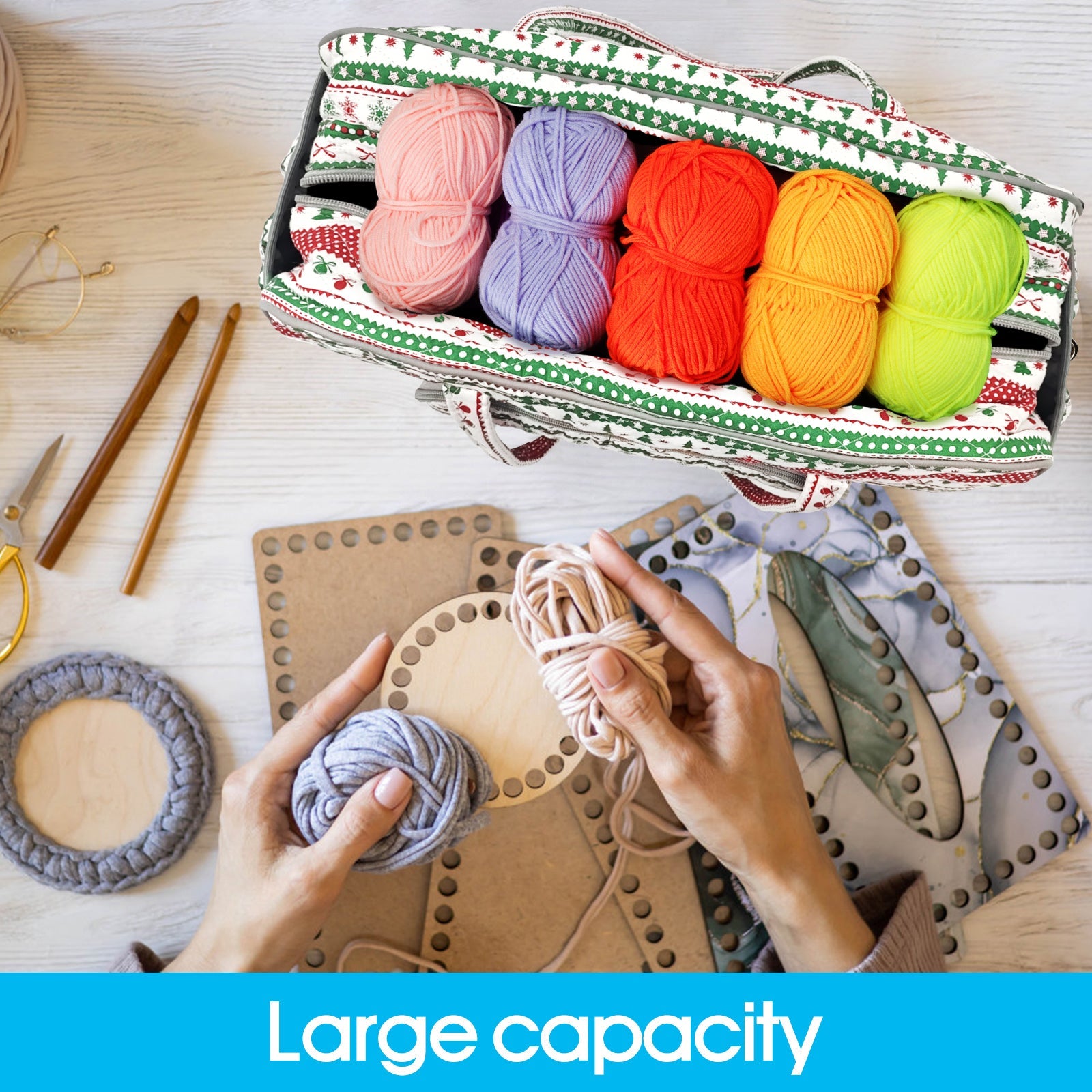 Large capacity bag for crochet in Christmas print holding colorful yarn beside crafting tools