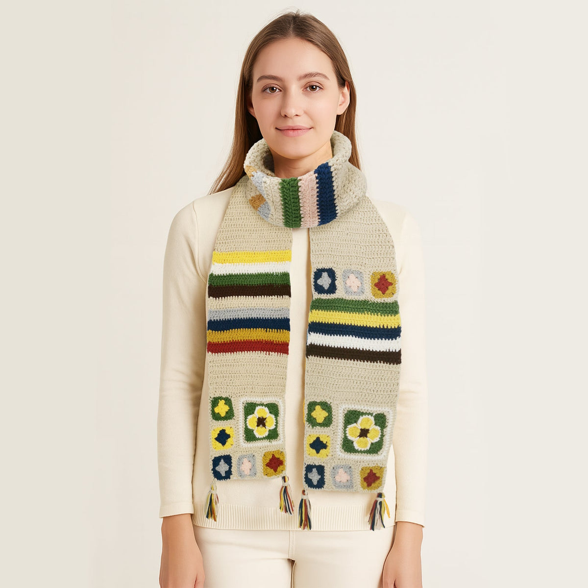 Woman wearing a creamy granny square crochet scarf with colorful patterns