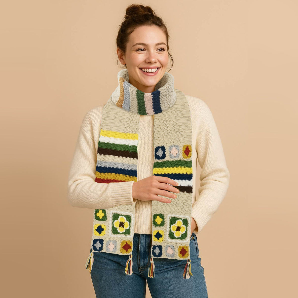 Woman wearing a creamy granny square crochet scarf with colorful stripes and patterns