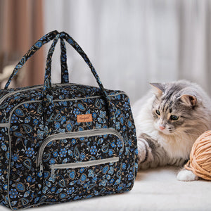 Woolique craft bag in black and blue paisley print shown in a cozy home setting with a pet