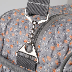Close-up detail of sturdy metal clasp and detachable strap on Woolique grey floral craft bag