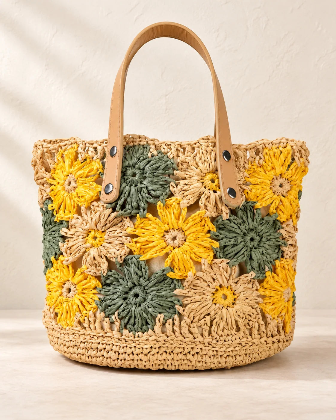 Floral raffia crochet bucket bag with a rounded shape
