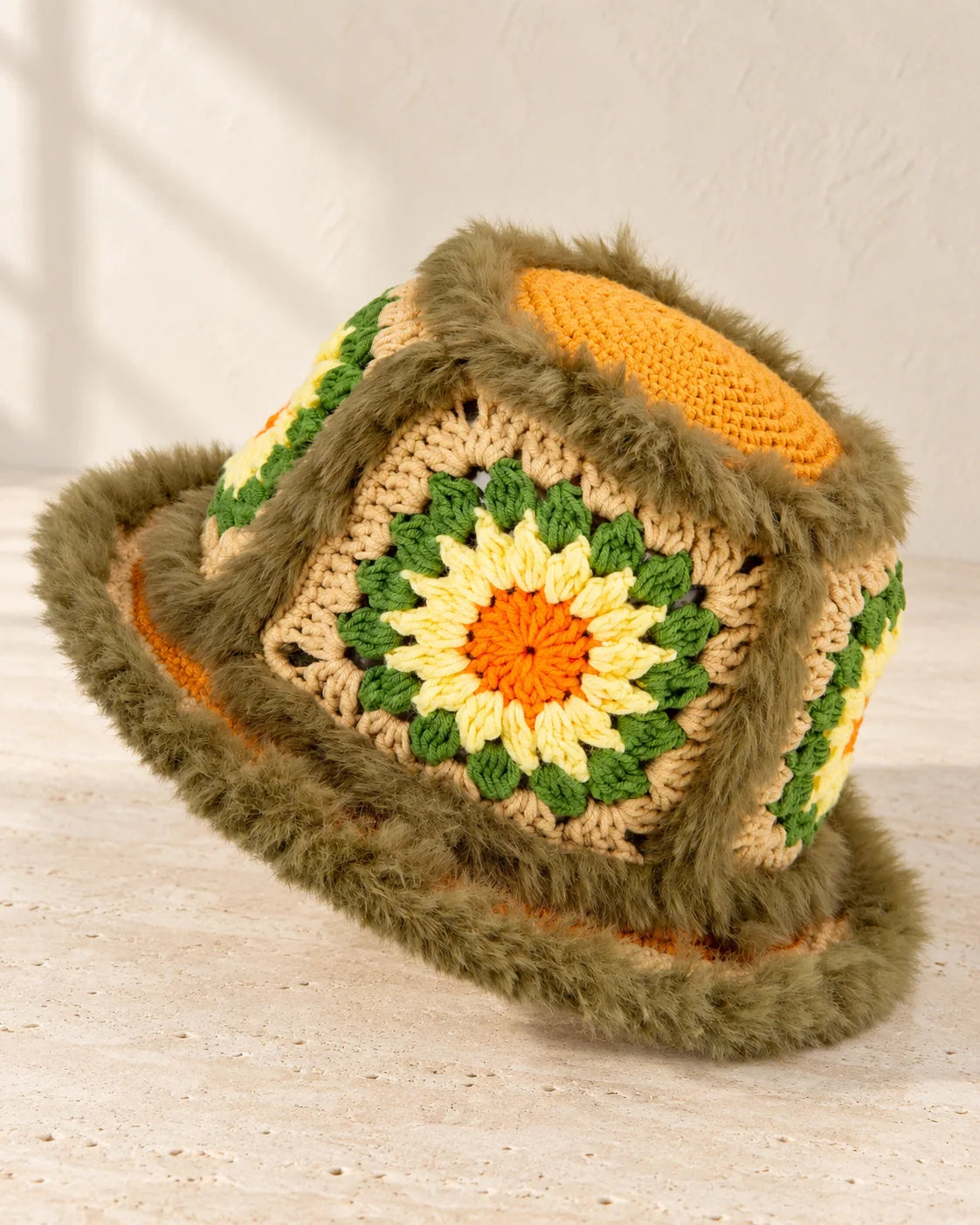 Fuzzy granny square bucket hat showing textured crochet squares and a shaped brim