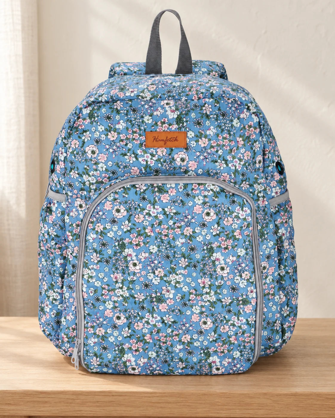 Woolique yarn storage backpack with tool compartments and yarn feed grommets