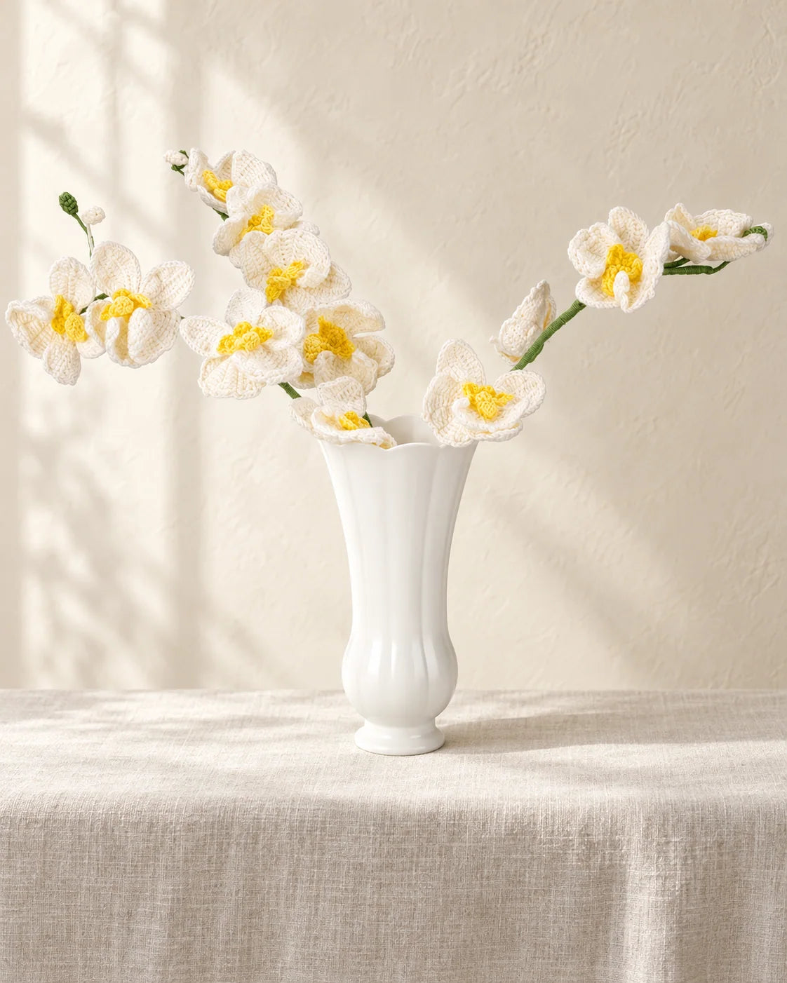 Crochet orchid arrangement with shaped petals, leaves and supported stems