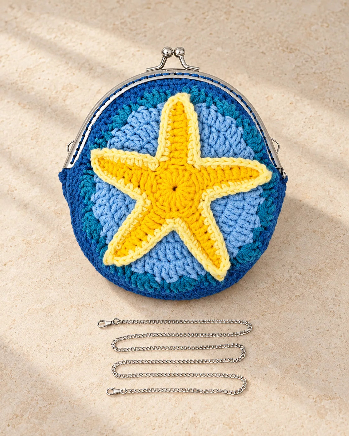 Blue crochet coin purse design with a raised starfish and metal kiss clasp